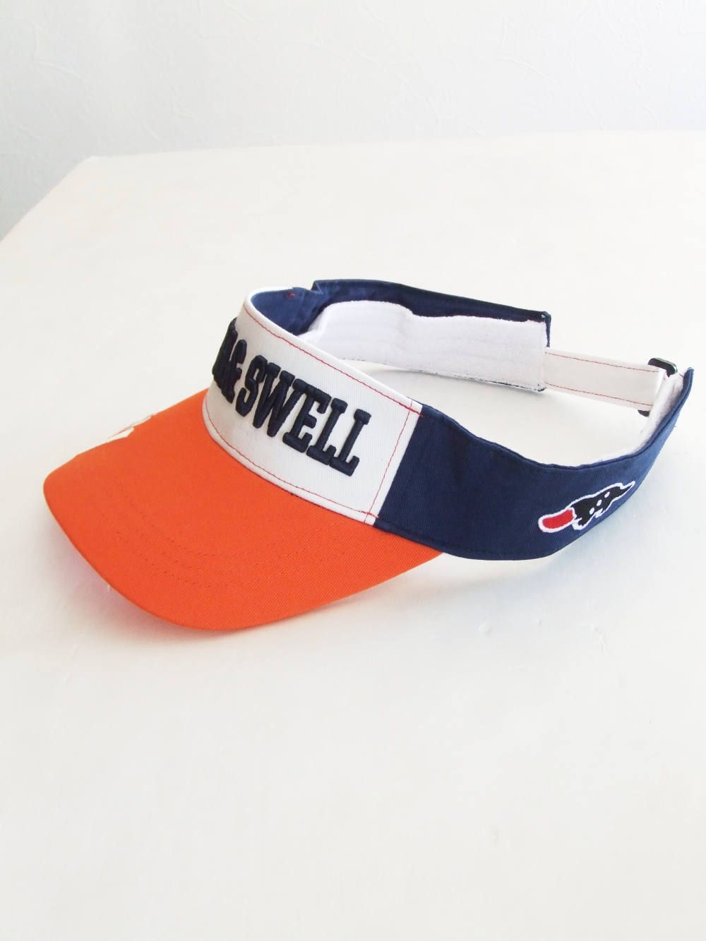 WORLD TOUR VISOR ( ORANGE × NAVY ) ロゴ入りバイザー