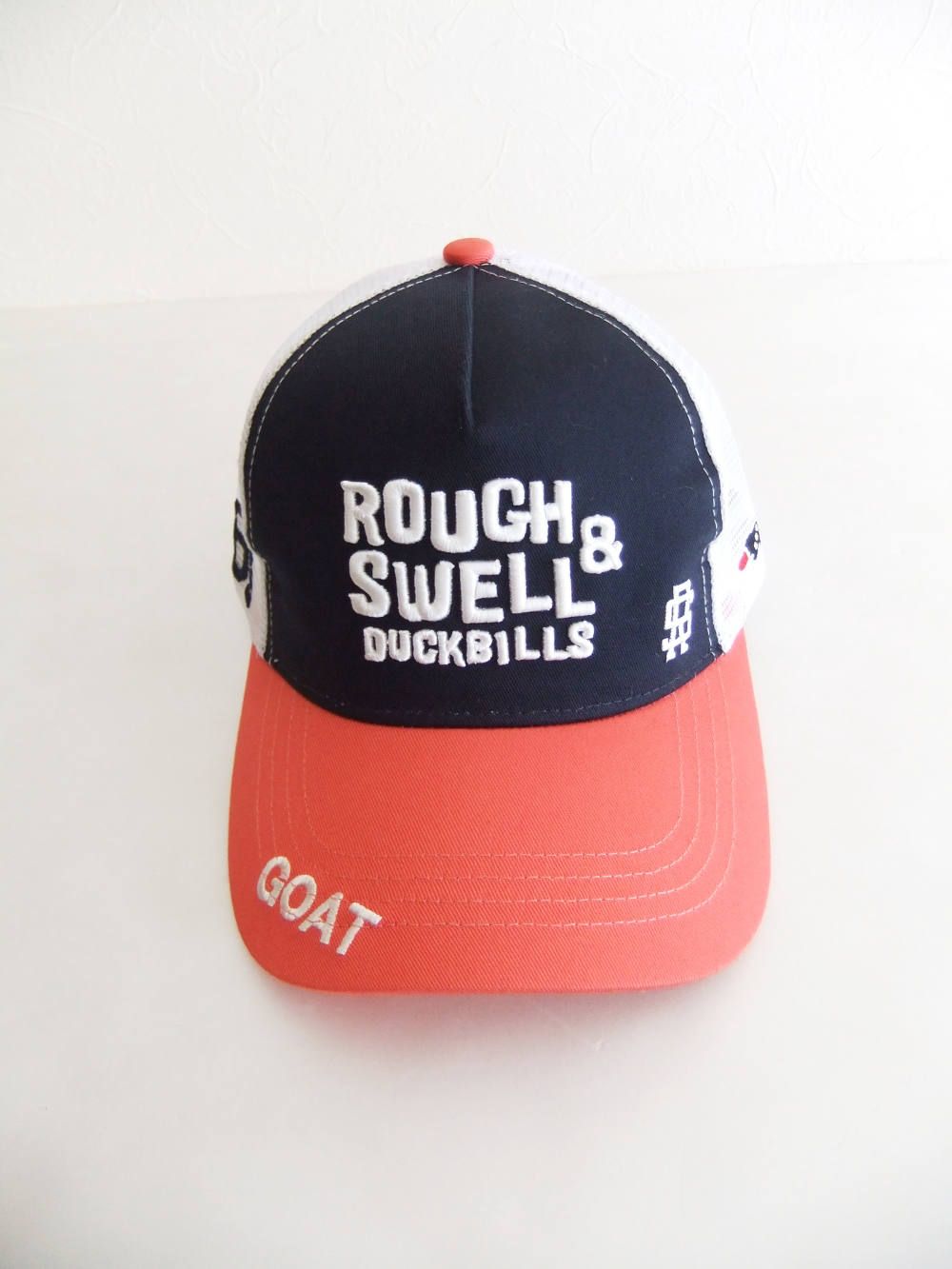 TRUCKER CAP ( ネイビー × オレンジ ) ロゴ入りキャップ