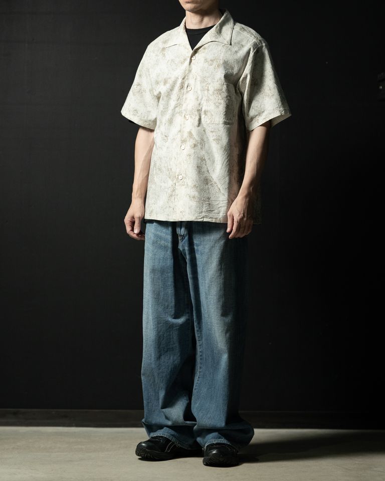 その庵治石（あじいし）が辿ってきた時間を服に閉じ込めようと、独特な表面の柄を拓本の技術を用いて写しどり、それをカスリ調の綿レーヨン生地の表面に落とし込んだ。