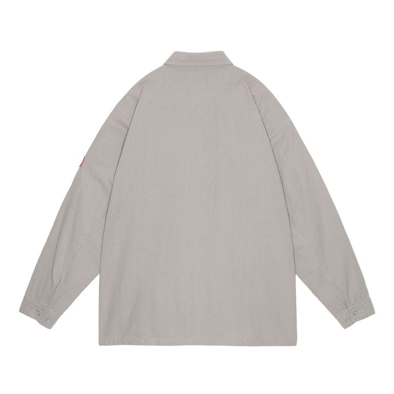 100%コットン。レギュラーポイントカラー。セットインスリーブ。前身頃ショルダーに刺繍でCAV EMPT。左袖上部にシリコンパッチ。シングルカフス。前身頃にウェルトポケット。ワイドシルエット。バイオウォッシュ加工。日本製。