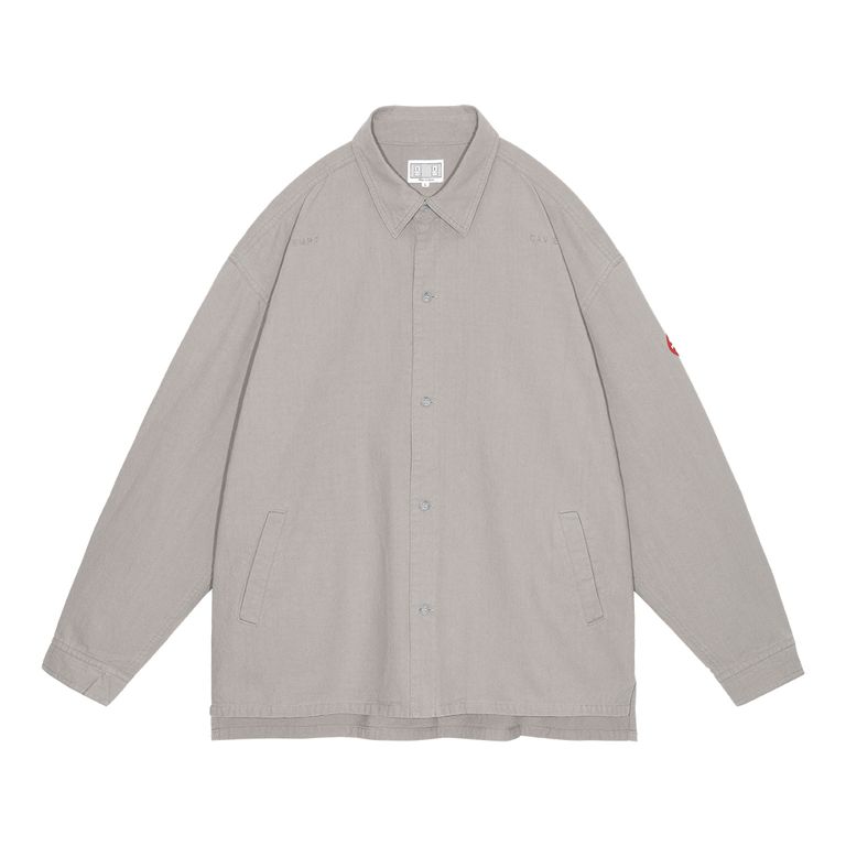 100%コットン。レギュラーポイントカラー。セットインスリーブ。前身頃ショルダーに刺繍でCAV EMPT。左袖上部にシリコンパッチ。シングルカフス。前身頃にウェルトポケット。ワイドシルエット。バイオウォッシュ加工。日本製。