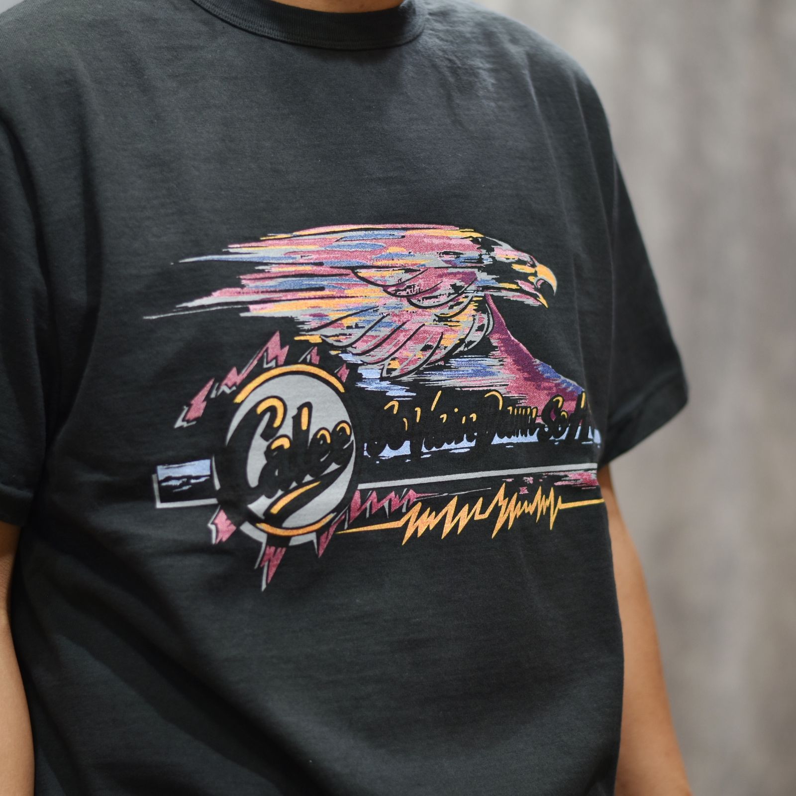 BINDER NECK EAGLE LOGO VINTAGE TEE ＜NATURALLY PAINT DESIGN＞ (BLACK) / プリントTシャツ