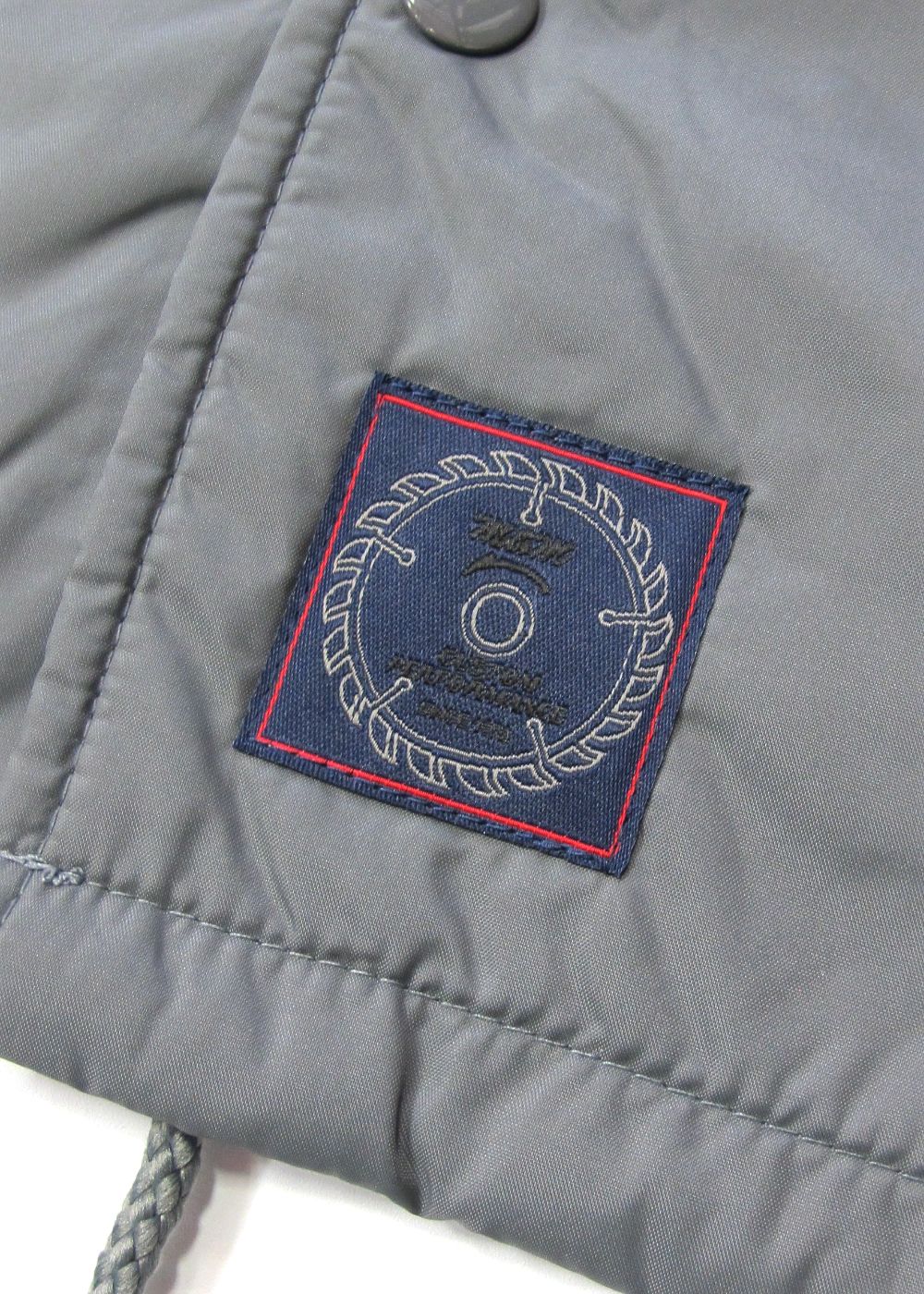 LOOPHOLE 20th ANNIVERSARY PRINT WINDBREAKER (CEMENT) / ループホール20周年記念 コーチジャケット