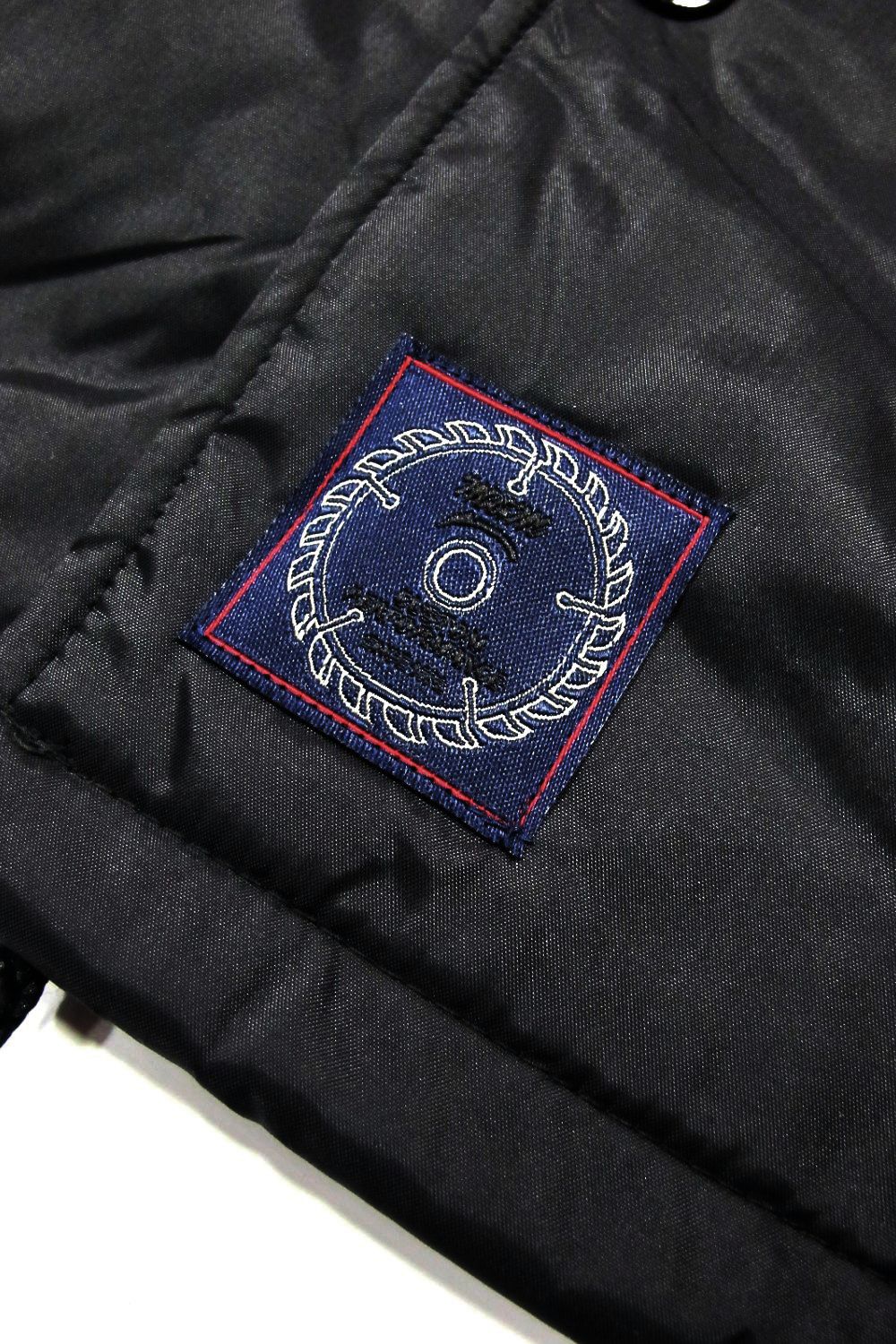 LOOPHOLE 20th ANNIVERSARY PRINT WINDBREAKER (BLACK) / ループホール20周年記念 コーチジャケット