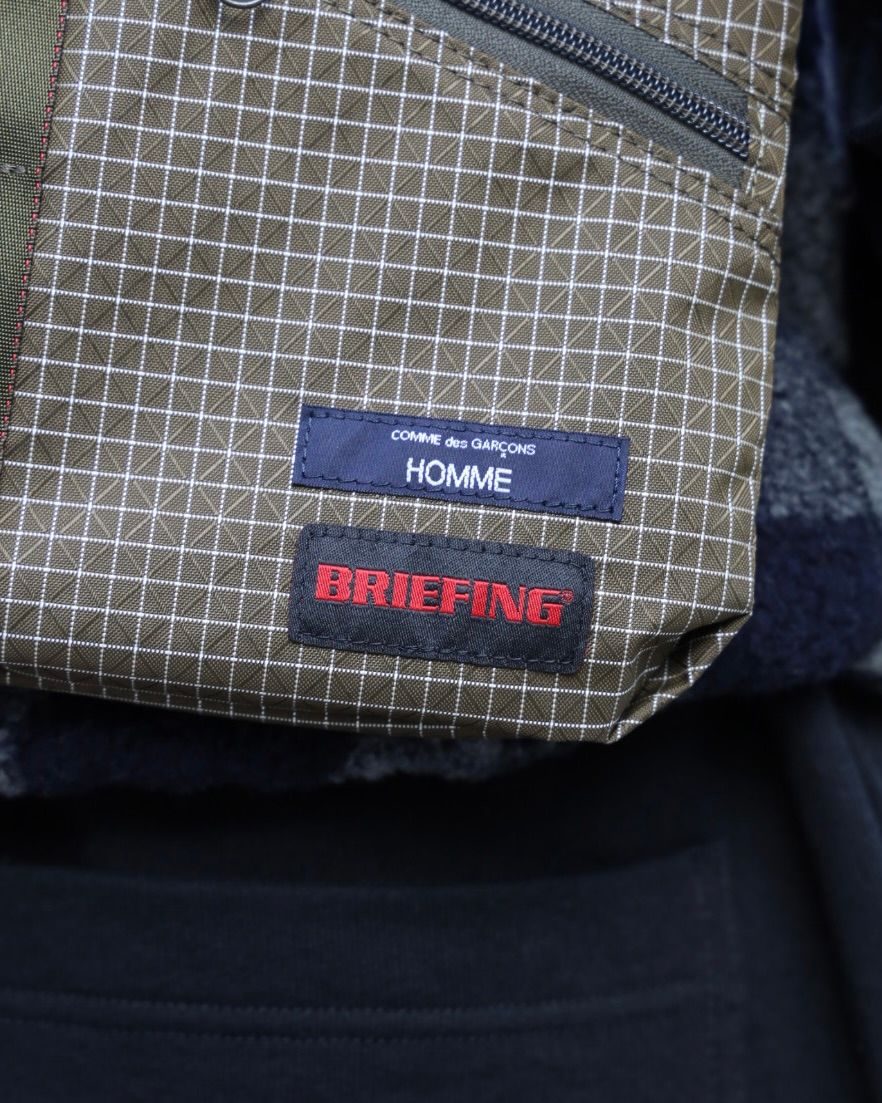 COMME des GARCONS HOMME BRIEFING W-NAME REVERSIBLE SACOCHE x ウールボアフリースベスト