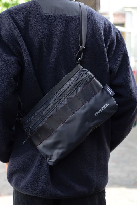 COMME des GARCONS HOMME BRIEFING W-NAME REVERSIBLE SACOCHE x エステルボアライナーカーディガン