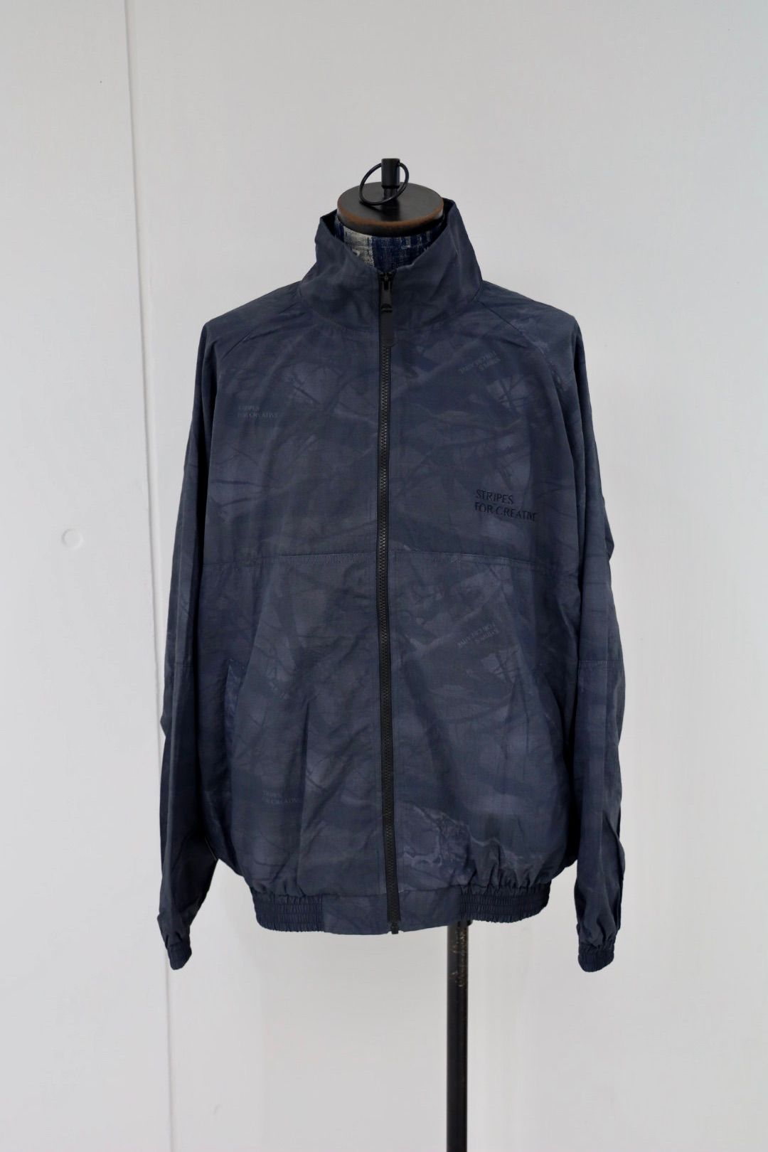 S.F.C 25FW エスエフシー WINDBREAKER JACKET (REAL TREE CAMO) (SFCFW25J06)Black Tree Camo