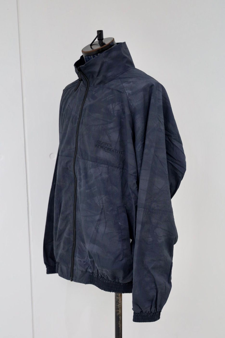 S.F.C 25FW エスエフシー WINDBREAKER JACKET (REAL TREE CAMO) (SFCFW25J06)Black Tree Camo