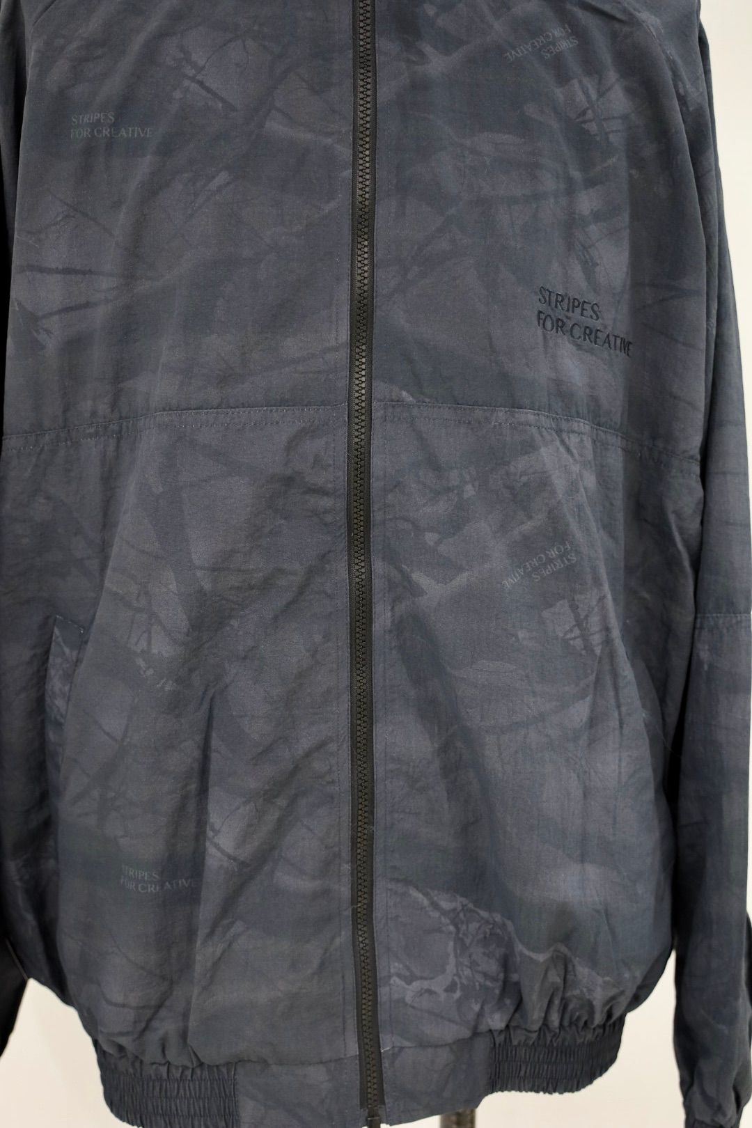 S.F.C 25FW エスエフシー WINDBREAKER JACKET (REAL TREE CAMO) (SFCFW25J06)Black Tree Camo