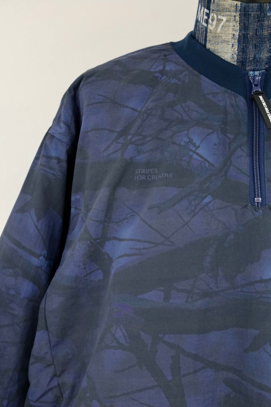 S.F.C 25FW エスエフシー BASEBALL HALF ZIP JACKET (SFCFW25J03)Navy Tree Camo