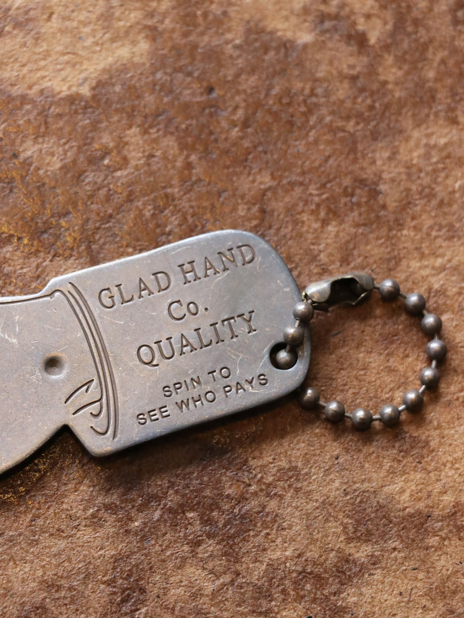 GLAD HAND & Co. - You Pay Spinner (Brass) | SKANDA